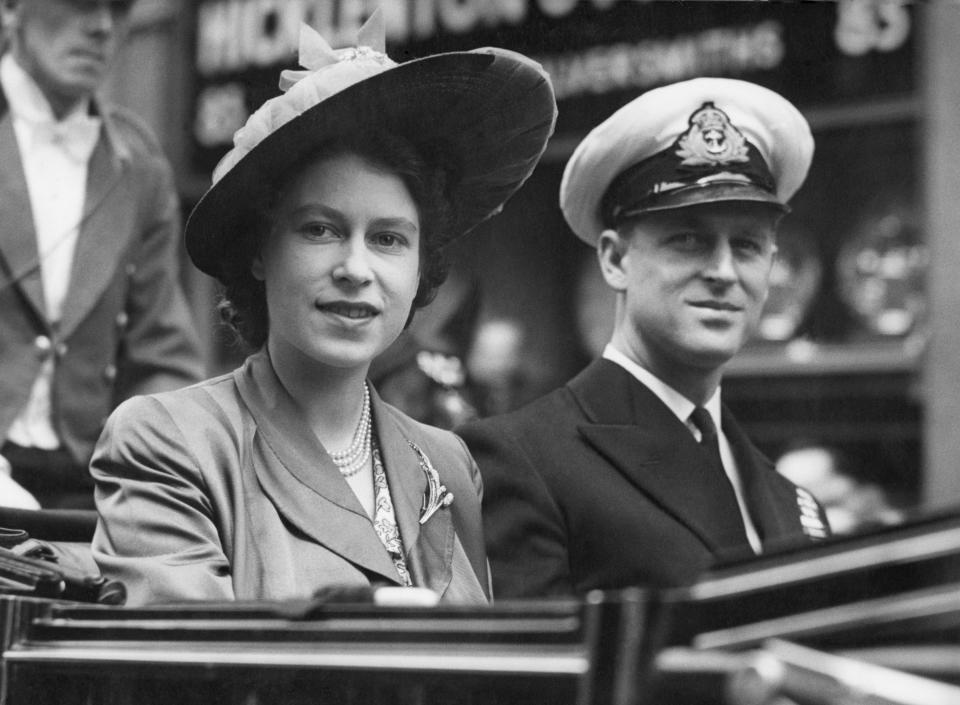 FILE - Britain's Princess Elizabeth smiles as she rides with Prince Philip, in an open Landau, as they drive from the Guildhall, in London, June 8, 1948, where he was made a Freeman of the City of London. Queen Elizabeth II will mark 70 years on the throne Sunday, Feb. 6, 2022, an unprecedented reign that has made her a symbol of stability as the United Kingdom navigated an age of uncertainty. (AP Photo/Leslie Priest, File)