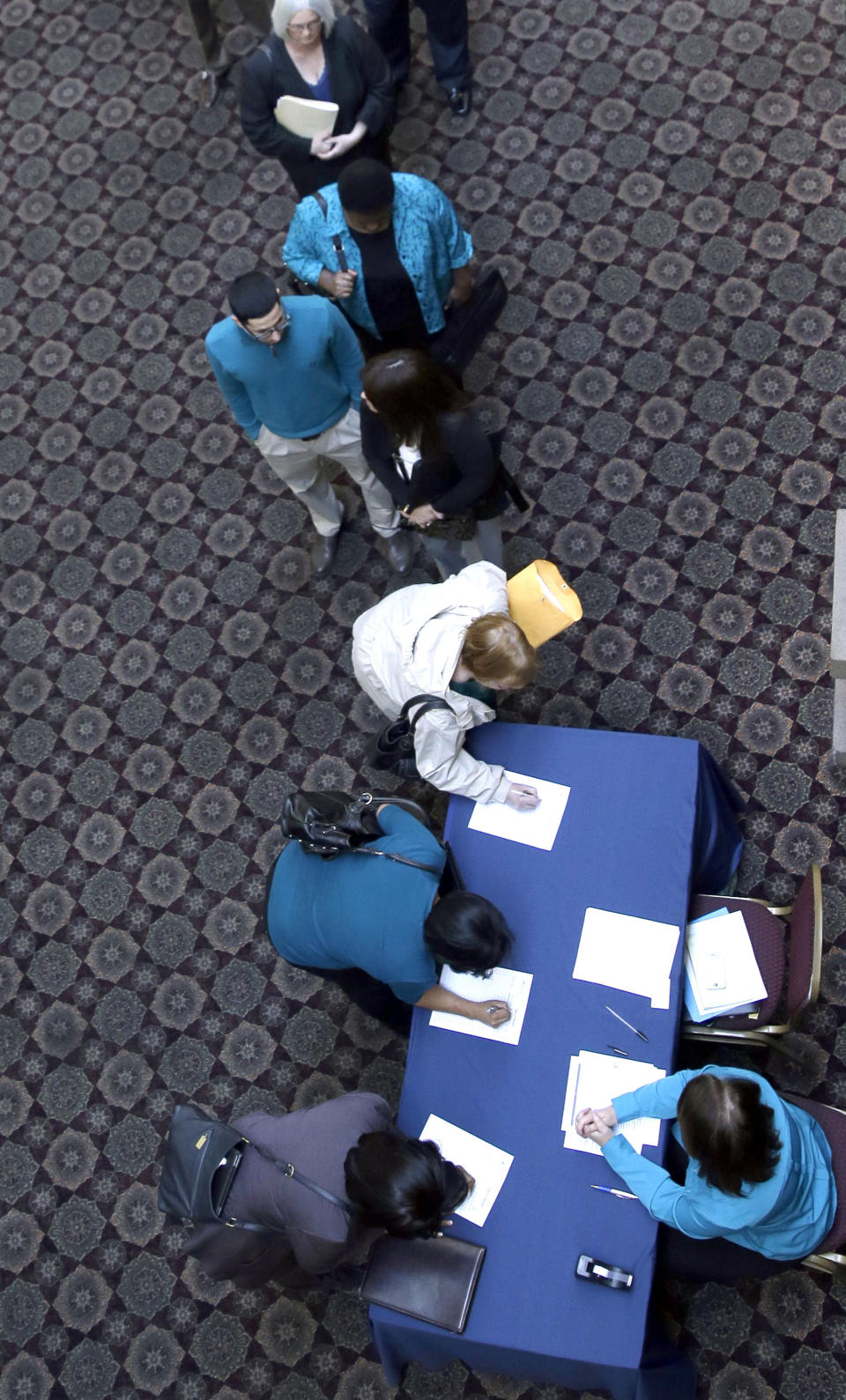 In this Wednesday, Jan. 22, 2014, photo, job seekers line up to meet prospective employers during a career fair at a hotel in Dallas. The government issues the January jobs report on Friday, Feb. 7. 2014. (AP Photo/LM Otero)