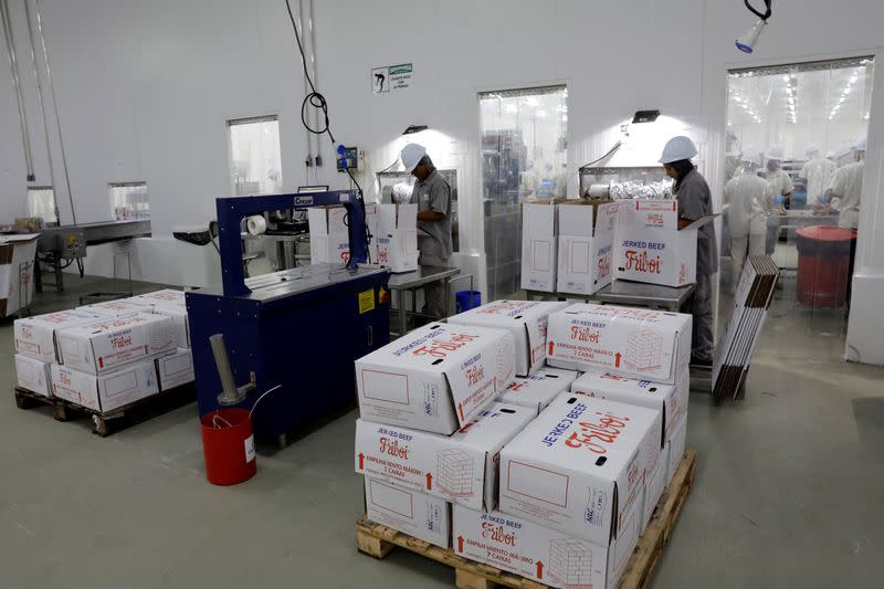 FILE PHOTO: Employees pack jerked beef at a plant of JBS S.A, the world's largest beef producer, in Santana de Parnaiba