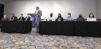 Houston Police officer Felipe Gallegos, fifth from right, listens as lawyer Rusty Hardin speaks during a press conference at Hilton Americas, Tuesday, Jan. 26, 2021, in Houston. Gallegos has been charged with murder and is among additional officers who have been indicted as part of an ongoing investigation into a Houston Police Department narcotics unit following a deadly 2019 drug raid, prosecutors announced Monday. (Karen Warren/Houston Chronicle via AP)