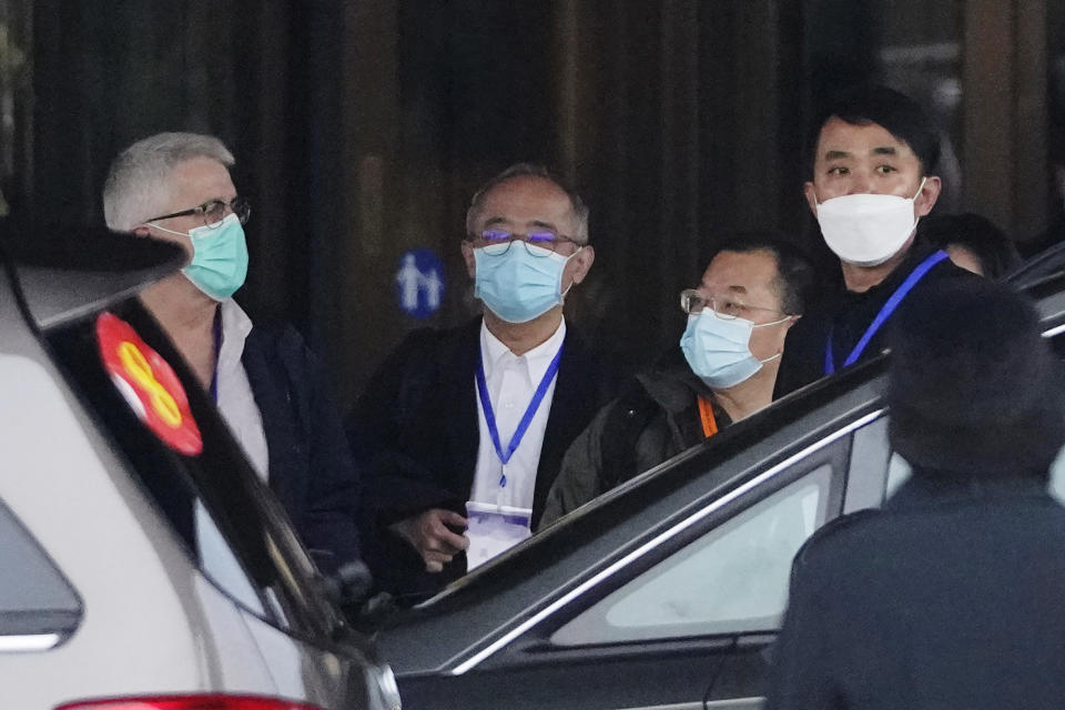 Ken Maeda, center, of the World Health Organization team prepares to leave for a third day of field visit in Wuhan in central China's Hubei province on Sunday, Jan. 31, 2021. (AP Photo/Ng Han Guan)