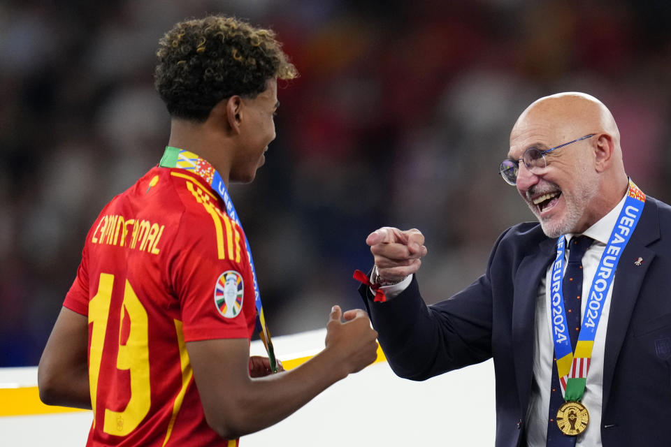 Spain's head coach Luis de la Fuente gestures to Lamine Yamal after they collected their medals for winning the final match between Spain and England at the Euro 2024 soccer tournament in Berlin, Germany, Sunday, July 14, 2024. Spain won 2-1. (AP Photo/Manu Fernandez)