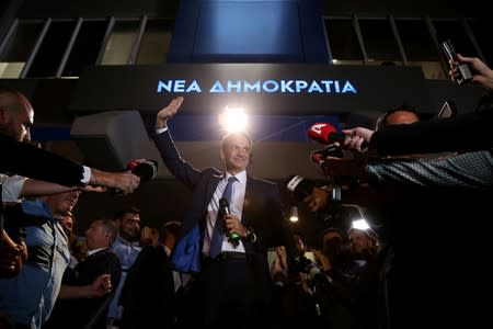 New Democracy conservative party leader Kyriakos Mitsotakis waves as he speaks outside party's headquarters, after the general election in Athens