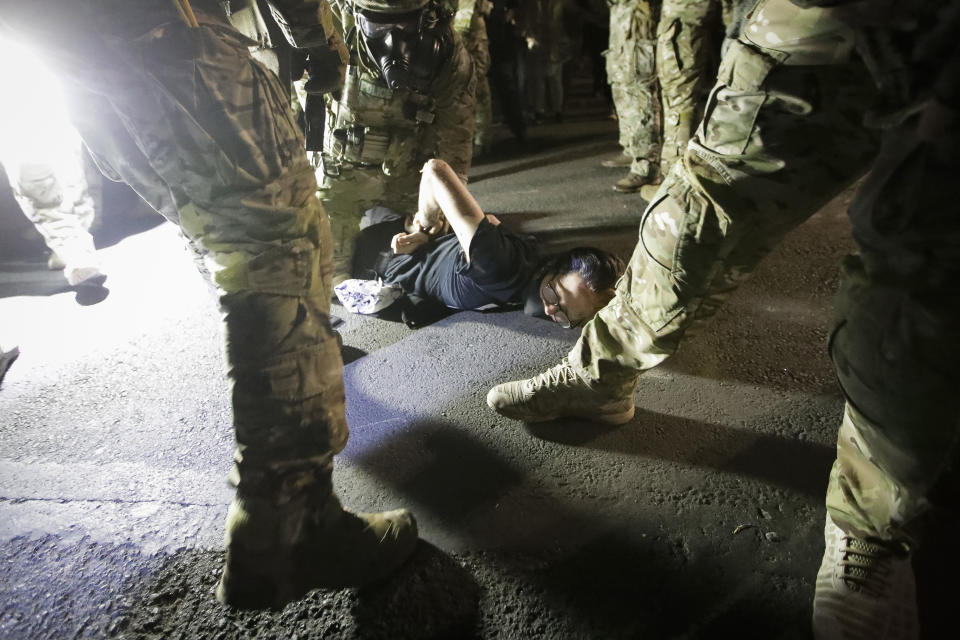 Federal agents arrest a demonstrator during a Black Lives Matter protest at the Mark O. Hatfield United States Courthouse Wednesday July 29, 2020, in Portland, Ore. (AP Photo/Marcio Jose Sanchez)