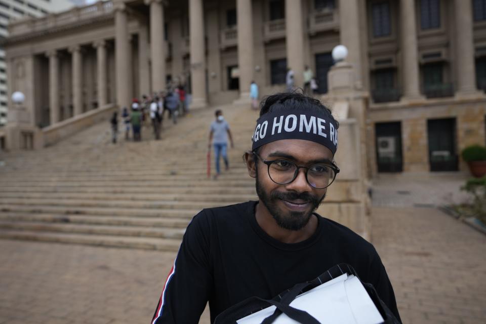 A protester leaves the president's office taking his belongings in Colombo, Sri Lanka, Thursday, July 21, 2022. (AP Photo/Eranga Jayawardena)