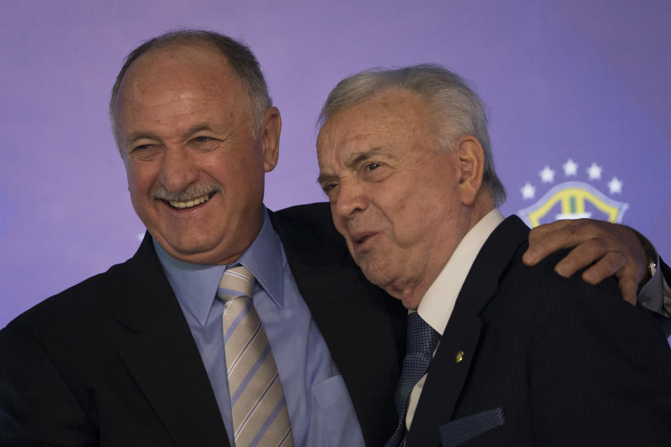 Brazil's soccer coach Luiz Felipe Scolari. left, embraces Brazilian Soccer Confederation President Jose Maria Marin during a news conference to anouce his list of players for the 2014 Soccer World Cup in Rio de Janeiro, Brazil, Wednesday, May 7, 2014. The team will mix talented young stars such as Neymar and Oscar with more experienced players such as Dani Alves, David Luiz, Thiago Silva and Hulk. (AP Photo/Felipe Dana)