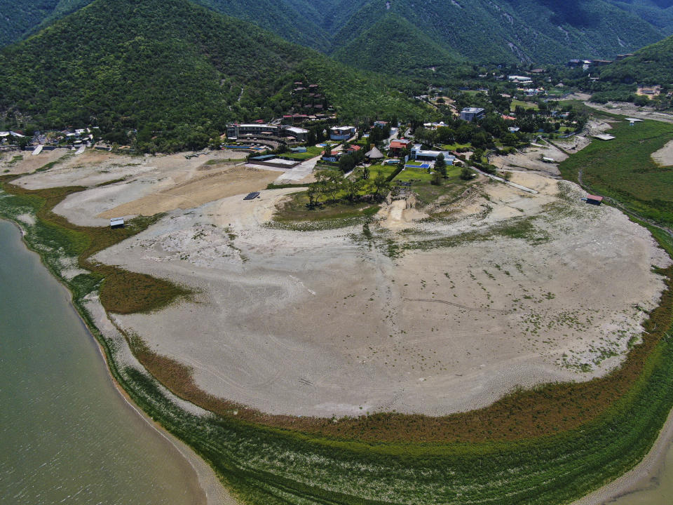 A view of The Boca reservoir that supplies water to the northern city of Monterrey is almost dry as the northern part of Mexico is affected by an intense drought, in Santiago, Mexico, Saturday, July 9, 2022. Local authorities began restricting water supplies in March, as a combination of an intense drought, poor planning and high use has left the three dams that help supply the city dried up, with thousands of homes not receiving any water for weeks. (AP Photo/Fernando Llano)