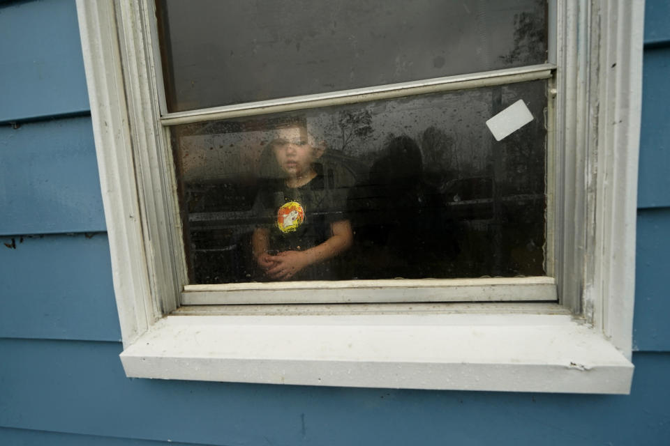 CORRECTS TO HUNTER FONTENOT NOT HUNTER DANIEL - Hunter Fontenot, 3, looks out the window of his uncle's house, to which his family temporarily relocated to ride out Hurricane Delta which is expected to make landfall later in the day, in Lake Charles, La., Friday, Oct. 9, 2020. (AP Photo/Gerald Herbert)