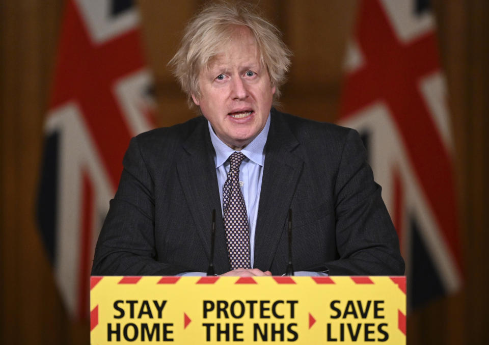 Britain's Prime Minister Boris Johnson speaks during a televised press conference at 10 Downing Street in London, Monday, Feb. 22, 2021. Johnson has announced a gradual easing of one of Europe’s strictest lockdowns, saying children will return to class and people will be able to meet a friend for coffee in a park in two weeks’ time. But people longing for a haircut, a restaurant meal or a pint in a pub have almost two months to wait, and people won’t be able to hug loved ones that they don’t live with until May at the earliest. (Leon Neal/Pool Photo via AP)