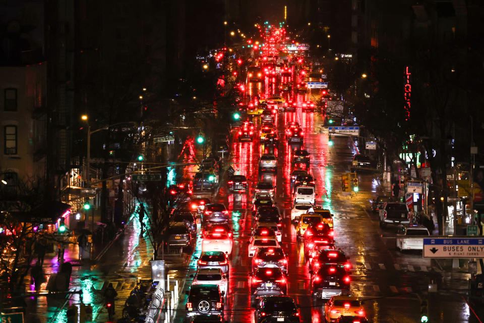 Pedestrians and cars move along First Avenue in pouring rain in Mahnhattan (Charly Triballeau  / AFP via Getty Images)