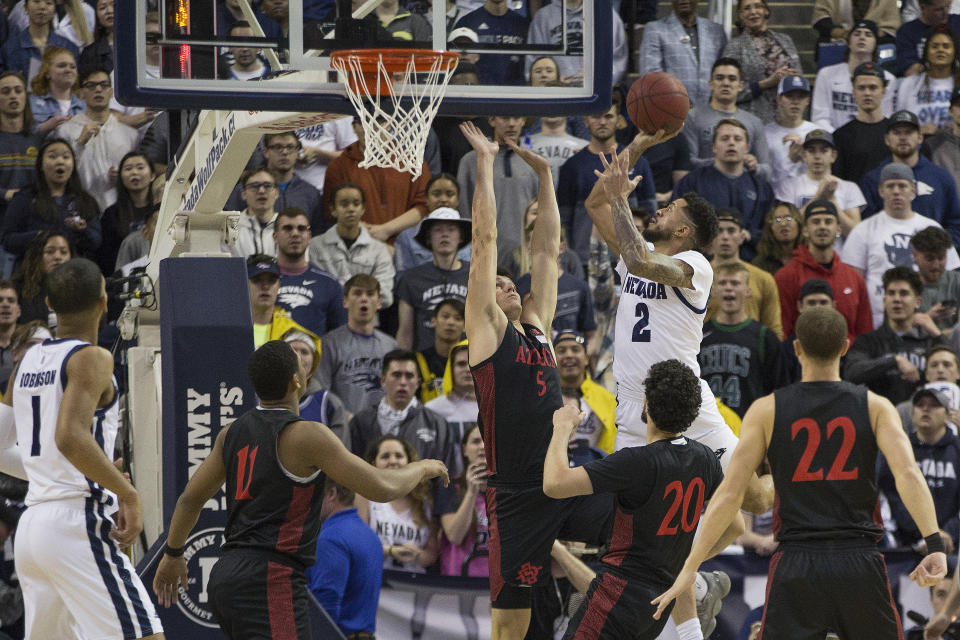 Nevada guard Jalen Harris (2) shoots over San Diego State forward Yanni Wetzell (5) during the first half of an NCAA college basketball game against San Diego State at Lawlor Events Center in Reno, Nev., Saturday, Feb. 29, 2020. (AP Photo/Tom R. Smedes)