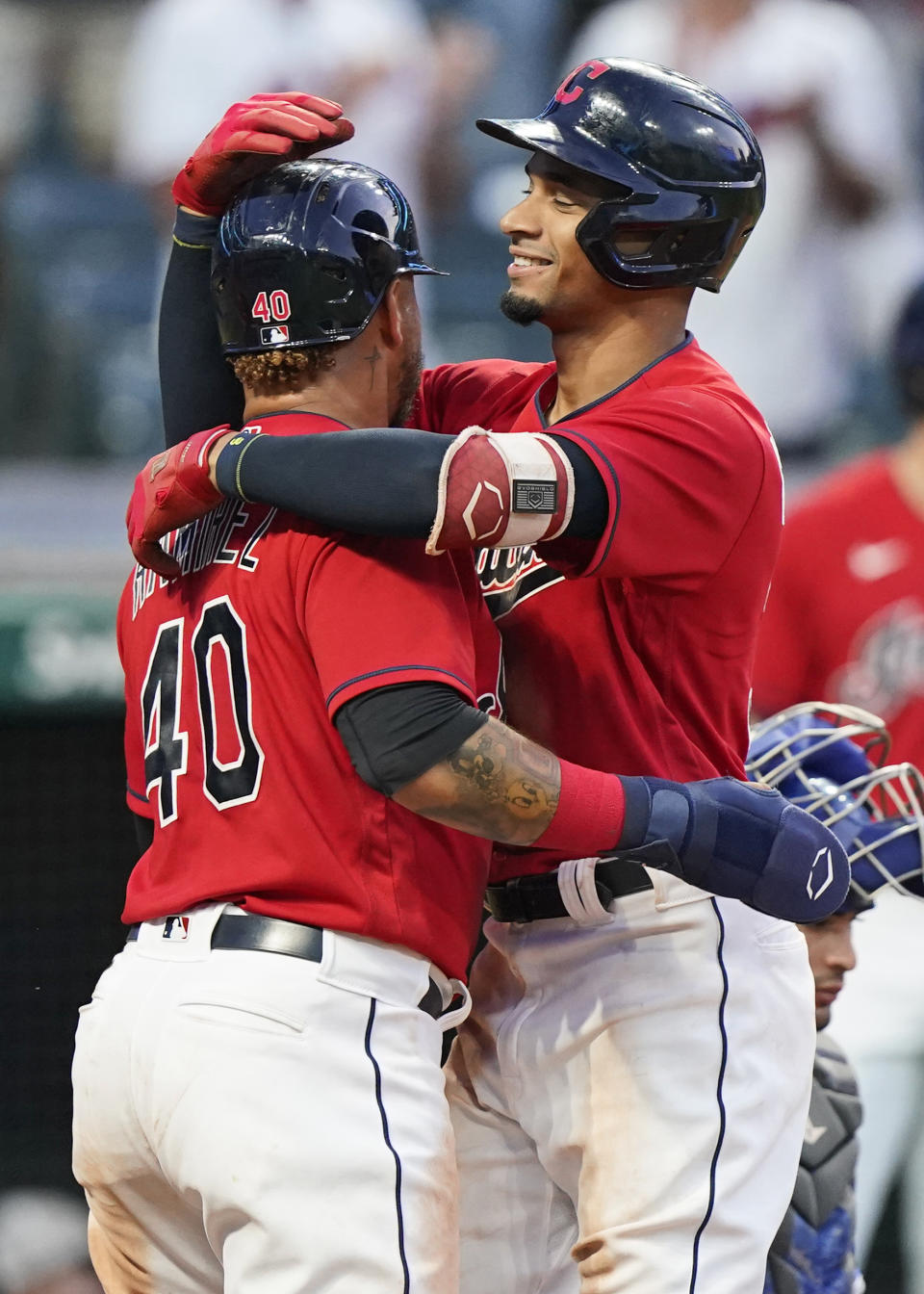 Cleveland Indians' Oscar Mercado, right, hugs Harold Ramirez after Mercado hit a three-un home run in the seventh inning of a baseball game against the Kansas City Royals, Saturday, July 10, 2021, in Cleveland. (AP Photo/Tony Dejak)