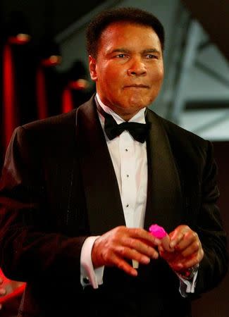 Former heavyweight boxing legend Muhammad Ali performs a magic trick during the "Tribute to Bambi" charity gala in the northern German town of Hamburg in this November 26, 2003 file phto. REUTERS/Christian Charisius/Files