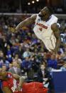 Florida center Patric Young (4) watches his shot as Dayton forward Dyshawn Pierre (21) falls to the floor during the second half in a regional final game at the NCAA college basketball tournament, Saturday, March 29, 2014, in Memphis, Tenn. (AP Photo/John Bazemore)
