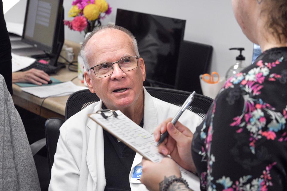 Volunteer physician Dr. William Liston talks with Cora Sternberg, nurse operations manager at the HOPE Medical Clinic in Destin. HOPE Medical Clinic has about 5,000 active patients served from offices in Destin and Freeport.