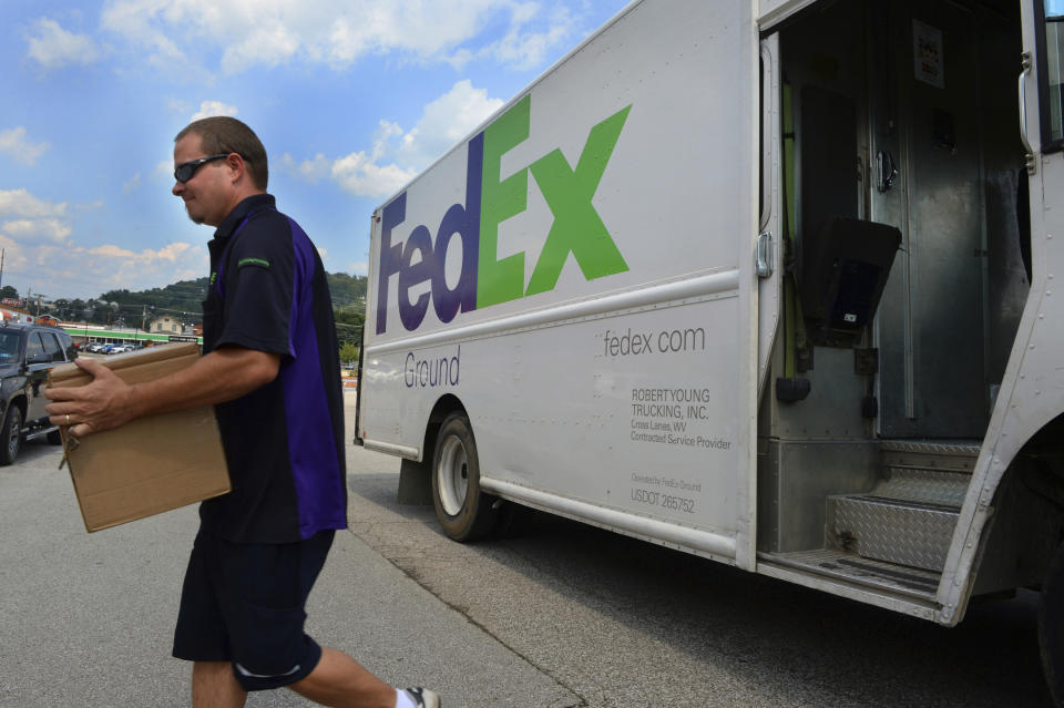 FedEx earnings will be in focus for markets on Tuesday. (Kenny Kemp/Charleston Gazette-Mail via AP)