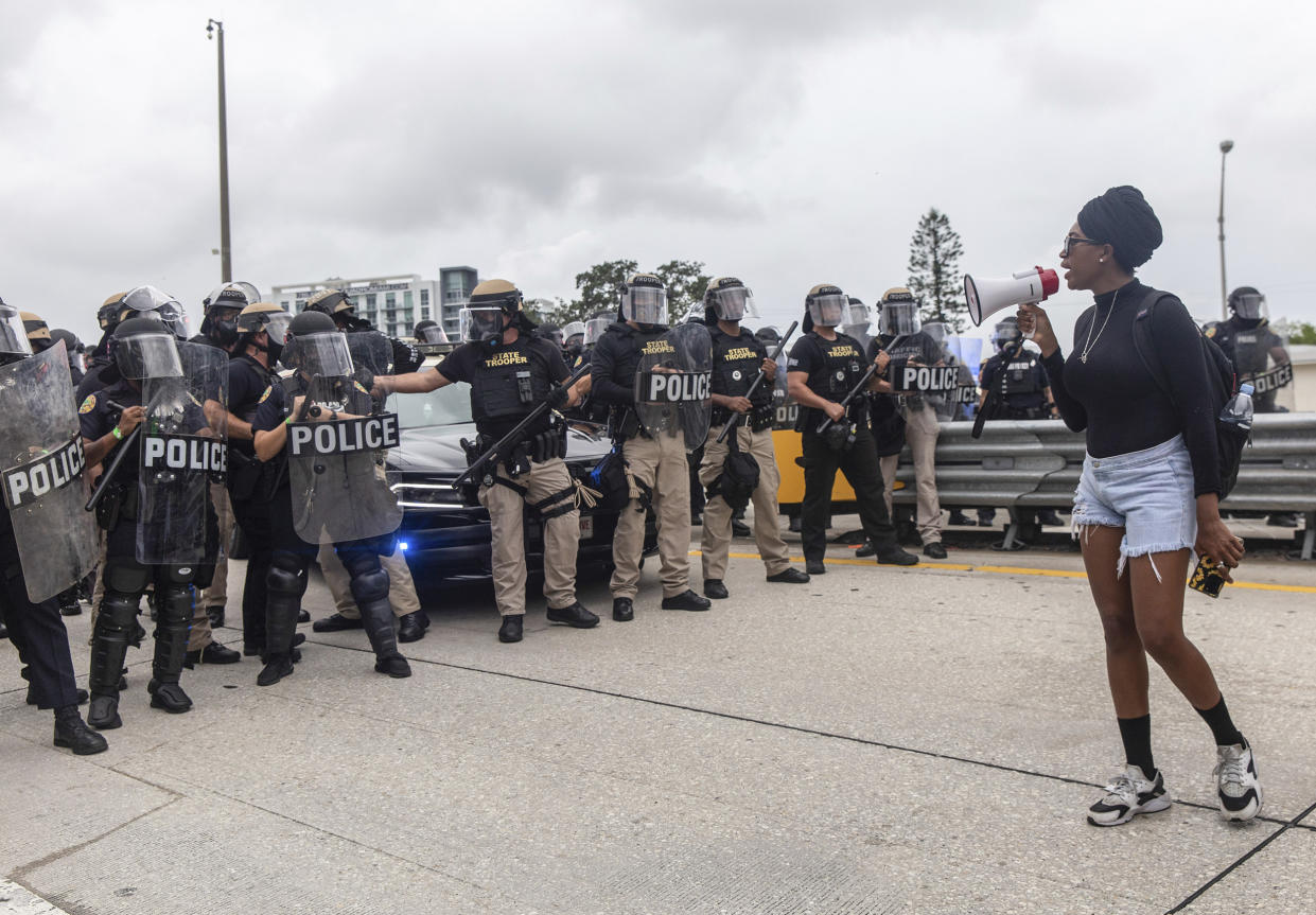 Image: A demonstrator addresses the riot police blocking the entrance to I-195 during a Black Lives Matter protest on June 5, 2020. (Adam DelGiudice / SOPA Images/Sipa USA via AP)