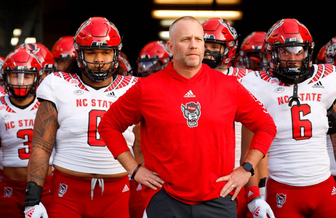 N.C. State head coach Dave Doeren prepares to lead the team onto the field before the Wolfpack’s game against UNC at Kenan Stadium in Chapel Hill, N.C., Friday, Nov. 25, 2022.