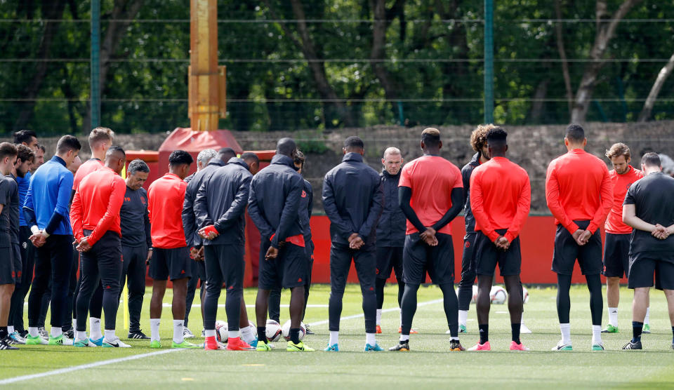 <p>Manchester United’s Wayne Rooney, center facing, stands alongside his teammates ahead of a training session at the AON Training Complex in Carrington, England, Tuesday May 23, 2017, for a minute of silence to remember the victims after an apparent suicide bomber attacked an Ariana Grande concert on Monday night. (Martin Rickett/PA via AP) </p>