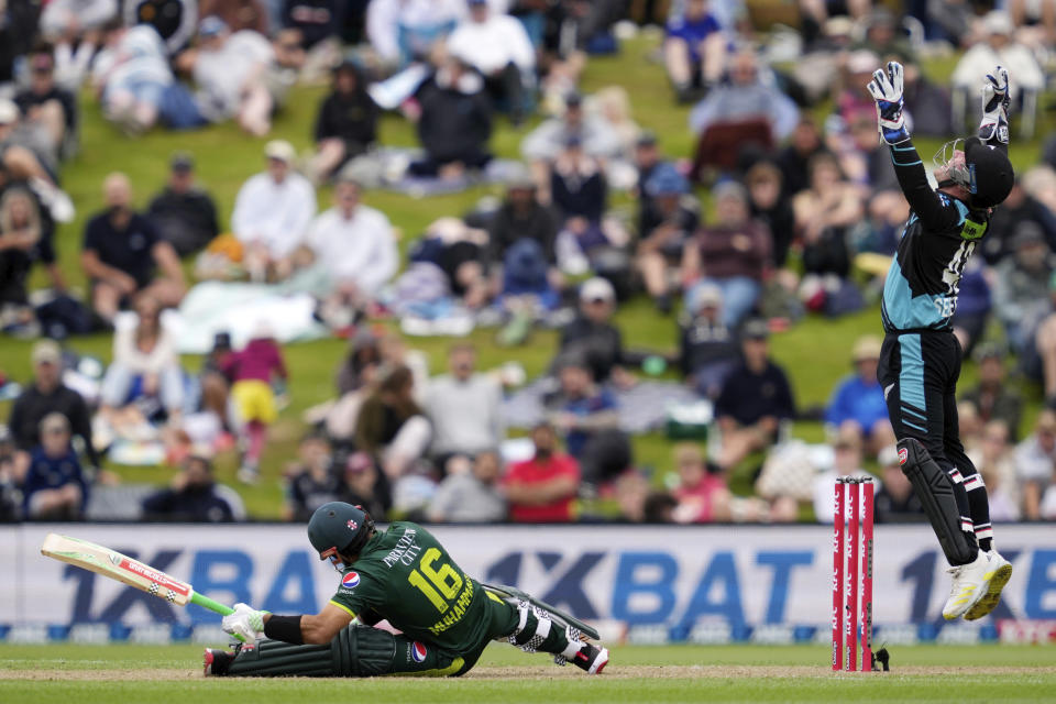 Mohammad Rizwan, left, is caught out by New Zealand's Tim Seifert, right, during their T20international cricket match in Dunedin, New Zealand, Wednesday, Jan. 17, 2024. (Michael Thomas/Photosport via AP)