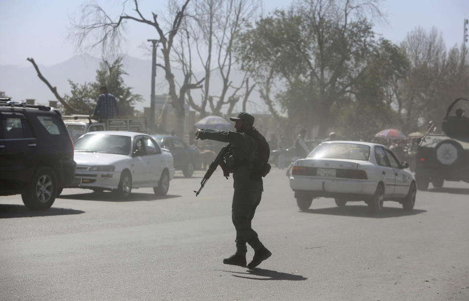 An Afghan security officer mans near a house where attackers are hiding, in Kabul, Afghanistan, Tuesday, Aug. 21, 2018. Afghan police say the Taliban fired rockets toward the presidential palace in Kabul as President Ashraf Ghani was giving his holiday message for the Muslim celebrations of Eid al-Adha. (AP Photo/Rahmat Gul)
