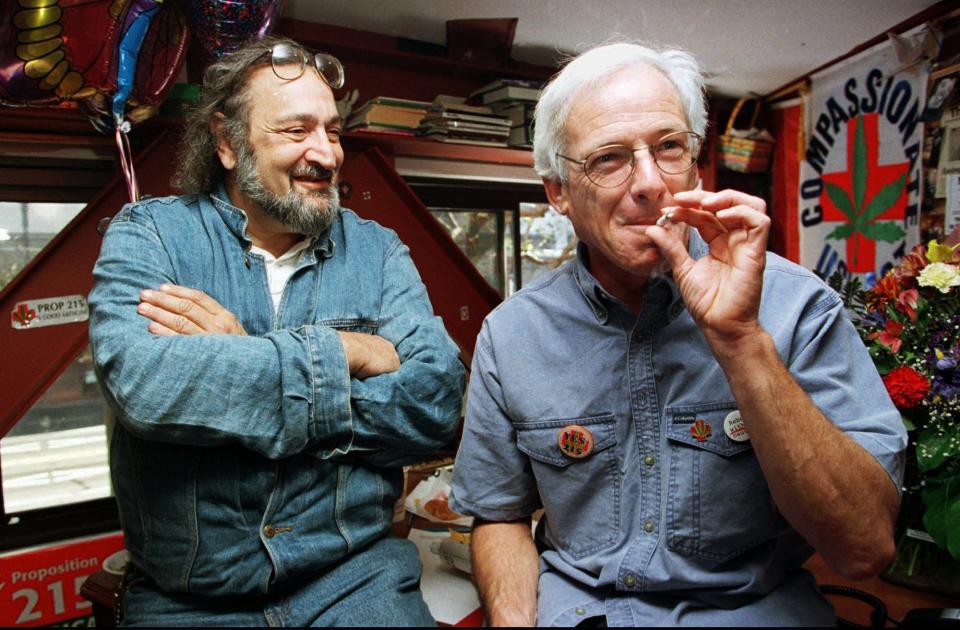 In this Nov. 6, 1996 file photo, Dennis Peron, right, leader of the campaign for California's Proposition 215 and founder of the Cannabis Buyers Club, smokes a marijuana cigarette next to Jack Herer, of Los Angeles, in San Francisco. Peron, who died in 2018, at age 72,  was a driving force behind a San Francisco ordinance allowing medical marijuana - a move that aided the 1996 passage of Proposition 215 legalizing medical marijuana use statewide.