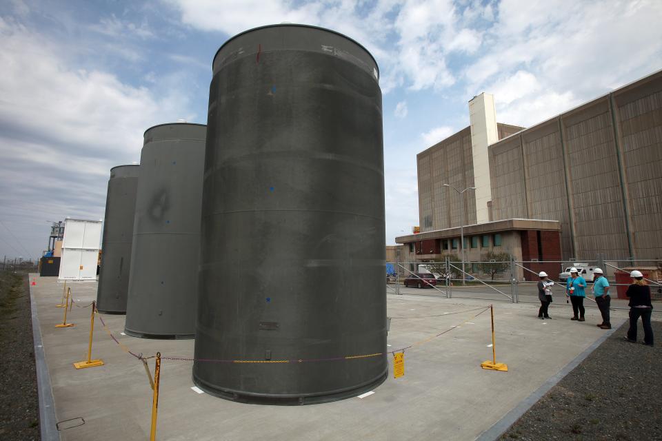 Spent fuel storage casks behind a warning sign at the Pilgrim Nuclear Power Station were photographed by the Times in May of 2015. The dry casks can hold up to 68 fuel assemblies and weigh up to 360,000 pounds each.