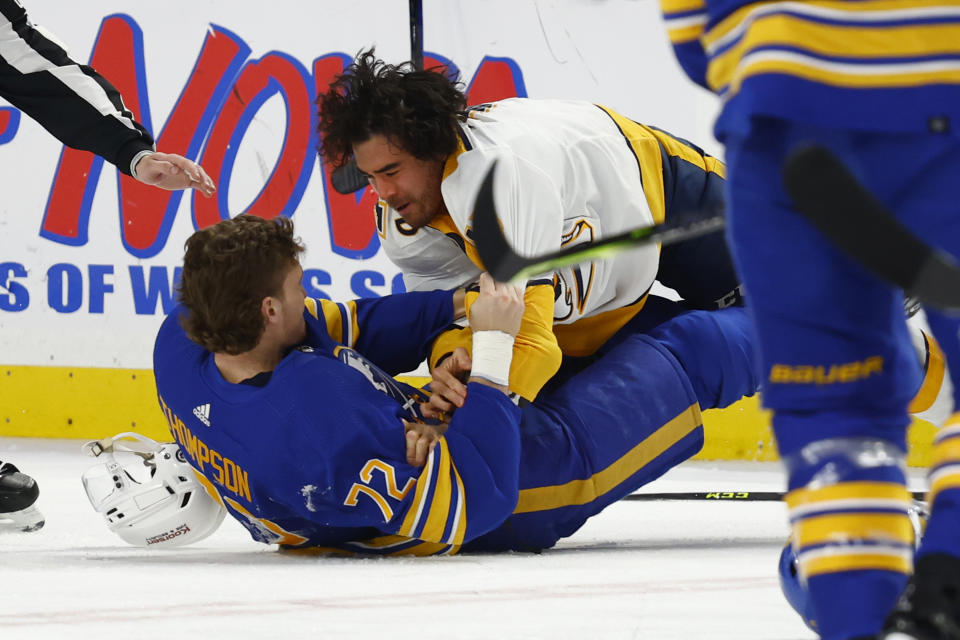 Buffalo Sabres center Dylan Cozens (24) and Nashville Predators left wing Kiefer Sherwood (44) fight during the second period of an NHL hockey game, Tuesday, March 21, 2023, in Buffalo, N.Y. (AP Photo/Jeffrey T. Barnes)