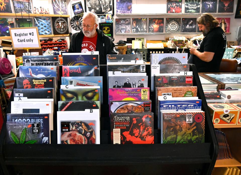 Kevin Howell (left) helps his son Jon ready The Record Guys for the Record Store Day rush Saturday. The display in front of them contains special releases for the day.