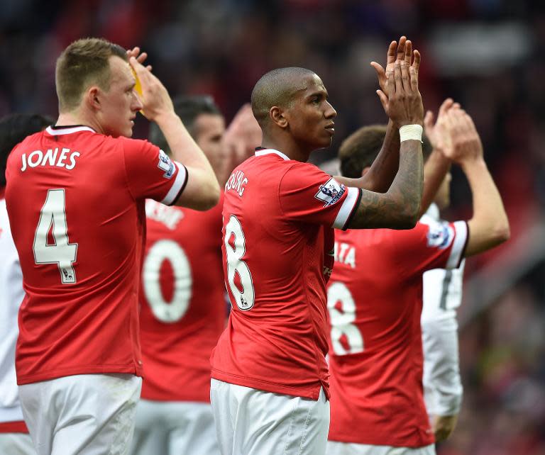 Manchester United's players applaud the crowd after their English Premier League match against Arsenal, at Old Trafford in Manchester, north-west England, on May 17, 2015