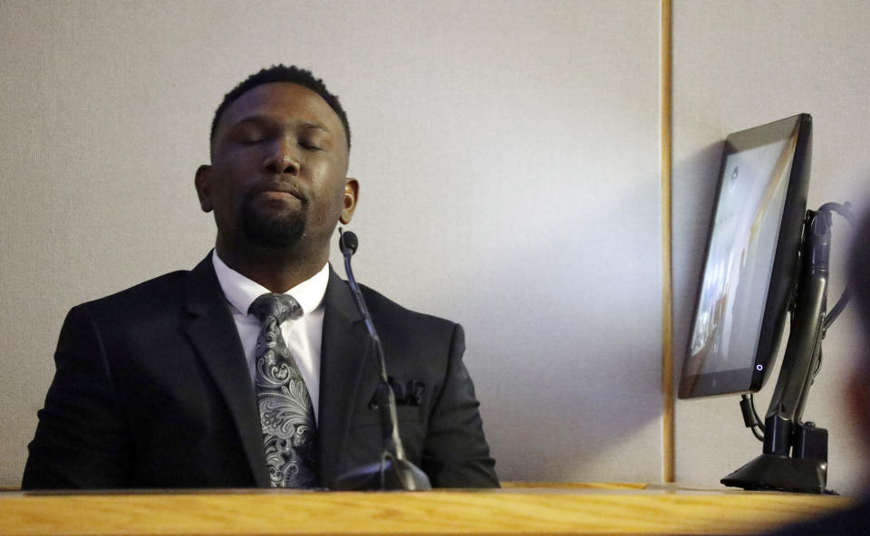 Dallas police officer Michael Lee, right, listens and watches his body cam footage played for the jury during the trial of former Dallas police officer Amber Guyger Tuesday, Sept. 24, 2019, in Dallas. Guyger is accused of shooting her unarmed black neighbor in his Dallas apartment. (Tom Fox/The Dallas Morning News via AP, Pool)