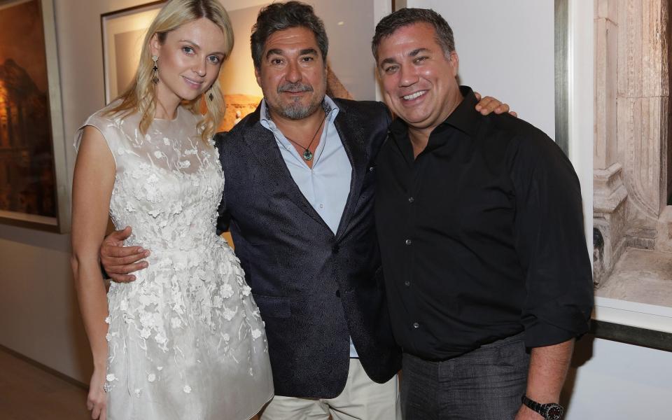 Todd Kozel (right) with Inga Kozel and Roberto Curran at the opening of the Robert Curran Gallery in Miami in 2014  - Getty