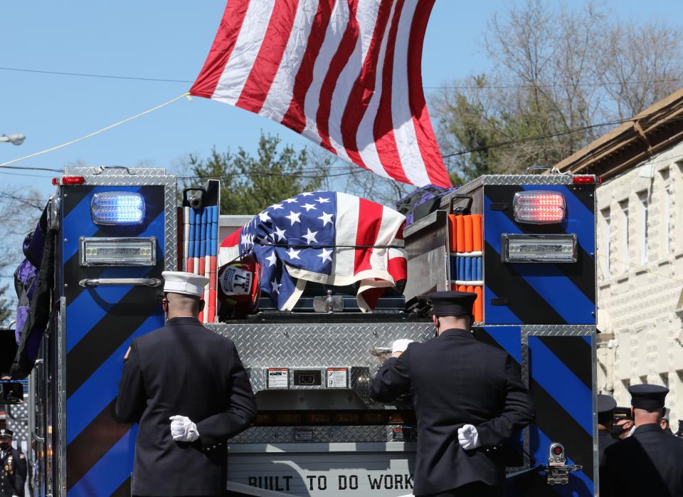 The Columbian Fire Engine Co. No.1 carries the casket of Jared Lloyd, as they stop for a moment in front of the firehouse on West Street in Spring Valley, after the funeral for Spring Valley firefighter Jared Lloyd, April 3, 2021. 