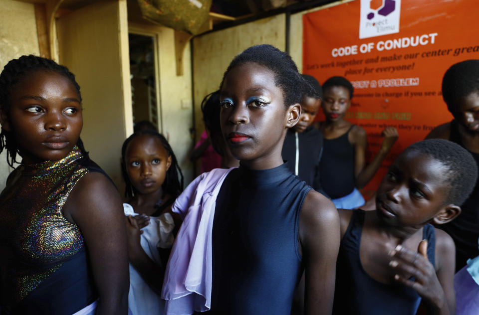 Young performers pose for a photo at Project Elimu social hall, prior to the start of a Christmas ballet event in Kibera, one of the busiest neighborhoods of Kenya's capital, Nairobi, Friday, Dec. 15, 2023. The ballet project is run by Project Elimu, a community-driven nonprofit that offers after-school arts education and a safe space to children in Kibera. (AP Photo/Brian Inganga)