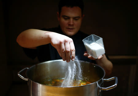 FILE PHOTO: A chef of Caffe Italia restaurant cooks soup as part of a charity program to help homeless people in St. Petersburg, Russia November 28, 2018. REUTERS/Anton Vaganov