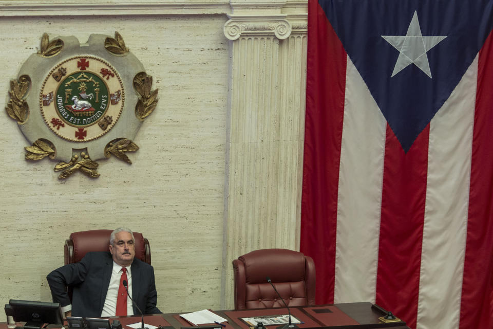 Puerto Rico Senate President Thomas Rivera Schatz sits in his chair at the Senate as discussions go on for the confirmation of Secretary of State Pedro Pierluisi as Puerto Rico's new Governor, in San Juan, Puerto Rico, Thursday, August 1, 2019. Puerto Rico's governing party was in full-blown crisis as the confirmation of Pierluisi was delayed into next week, casting doubt over exactly who will become governor when Gov. Ricardo Rossello leaves office. Pierluisi's main obstacle appeared to be Rivera Schatz, who has said he won't vote for Rosselló's nominee and wants to run for governor himself next year. (AP Photo/Dennis M. Rivera Pichardo)