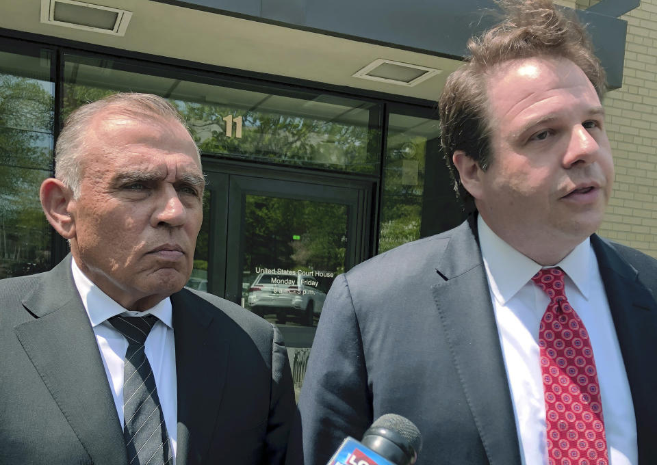 Ariel Quiros, left, former owner of Jay Peak Resort, stands with his lawyer Seth Levine outside the federal courthouse, Wednesday, May 22, 2019, in Burlington, Vt., after his arraignment on fraud charges over a failed plan to build a biotechnology plant using foreign investors' money. (AP Photo/Lisa Rathke)