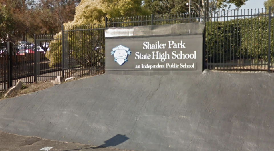 A sign on a fence says Shailer Park State High School, the location where a student was stabbed. 