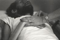 A nurse at Pater Noster House in Ohio holds David Kirby's hands not long before he died, spring 1990. (© Therese Frare) <br> <br> <a href="http://life.time.com/history/behind-the-picture-the-photo-that-changed-the-face-of-aids/#1" rel="nofollow noopener" target="_blank" data-ylk="slk:Click here to see the full collection at LIFE.com;elm:context_link;itc:0;sec:content-canvas" class="link ">Click here to see the full collection at LIFE.com</a>