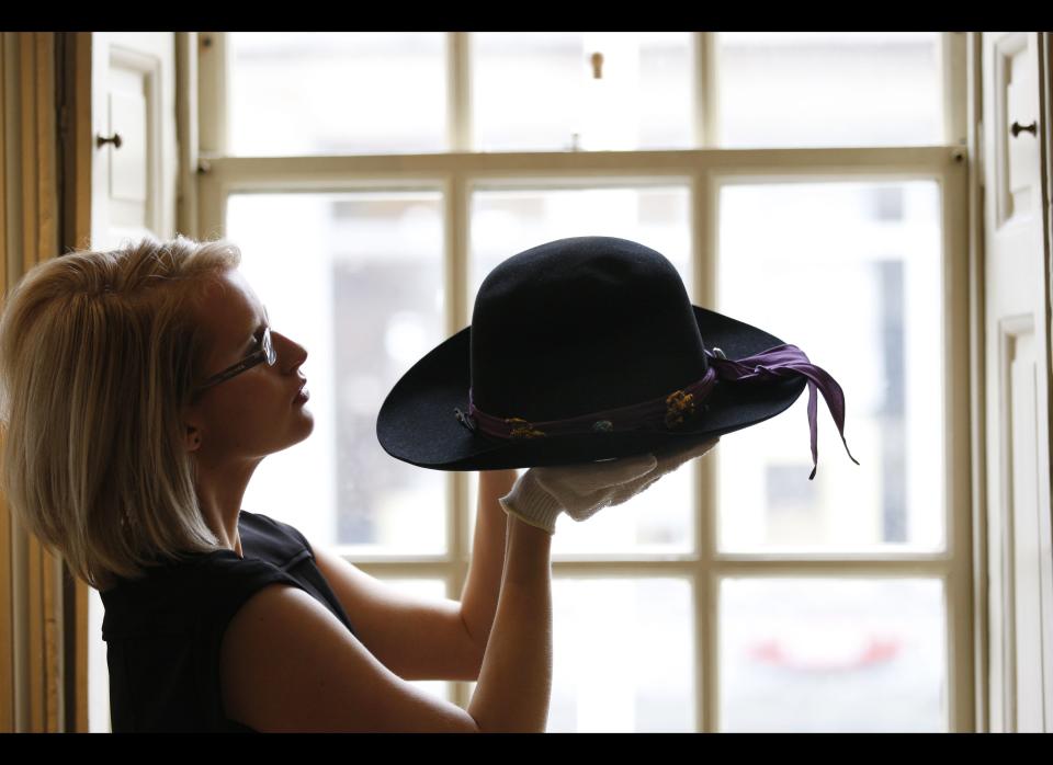 Marketing manager of the museum Gemma Morris poses with Jimi Hendrix's 'Westerner' hat.     AP Photo/Sang Tan