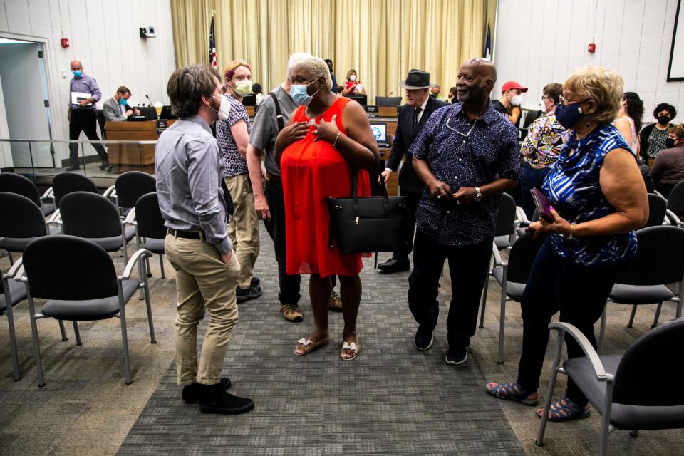 Royceann Porter, chairperson of the Johnson County Board of Supervisors, center, speaks with Justin Comer of Coralville, a producer of the Rock Hard Caucus podcast, after an emergency special council meeting, Thursday, Aug. 4, 2022, at the Emma J. Harvat Hall inside City Hall in Iowa City, Iowa.