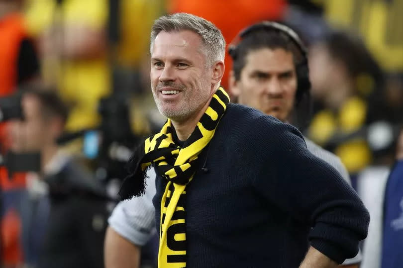 Jamie Carragher wears a Borussia Dortmund scarf ahead of the German club's Champions League semi-final against PSG