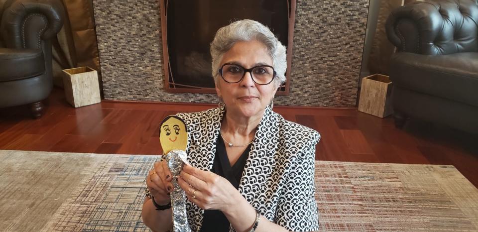 Kalpana Sharma, a preschool teacher in Washington, D.C., is one of the first teachers in the district to record lessons for broadcast television to reach students without home computers or internet. She poses with one of her homemade props, a spatula puppet.