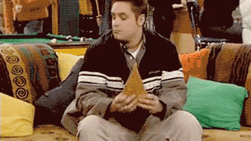 Eric Matthews aggressively eating a slice of pizza in "Boy Meets World"