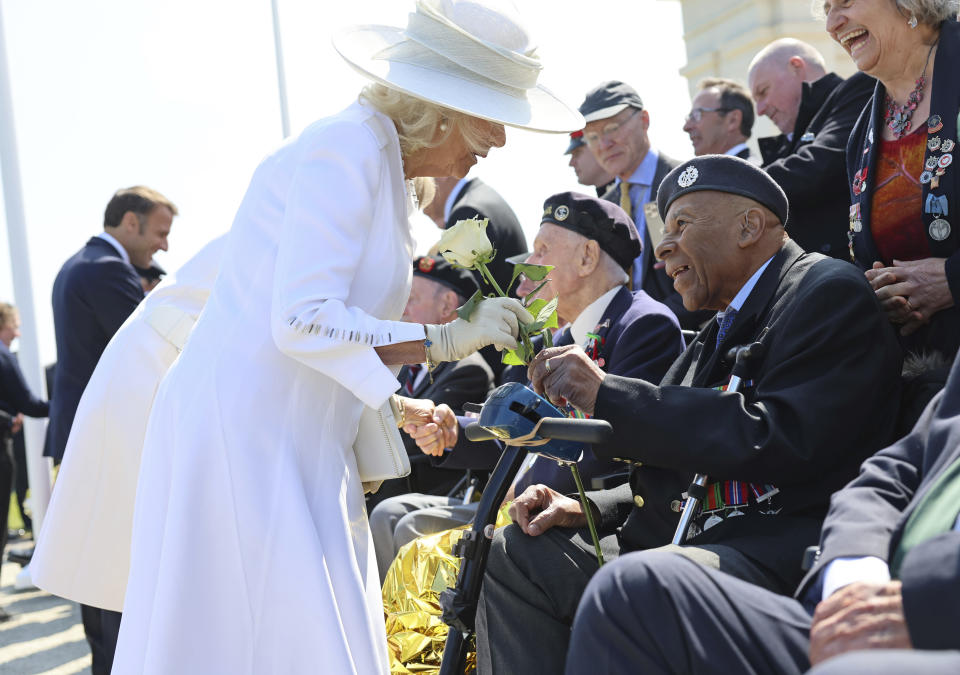 Britain's Queen Camilla receives a white rose from veteran Gilbert Clarke, during the UK Ministry of Defence and the Royal British Legion's commemorative event at the British Normandy Memorial to mark the 80th anniversary of D-Day, in Ver-Sur-Mer, France, Thursday, June 6, 2024. (Chris Jackson, Pool Photo via AP)