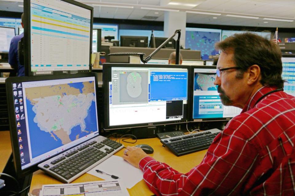 A Delta employee manages flights in the airline's operations center. Delta Air Lines