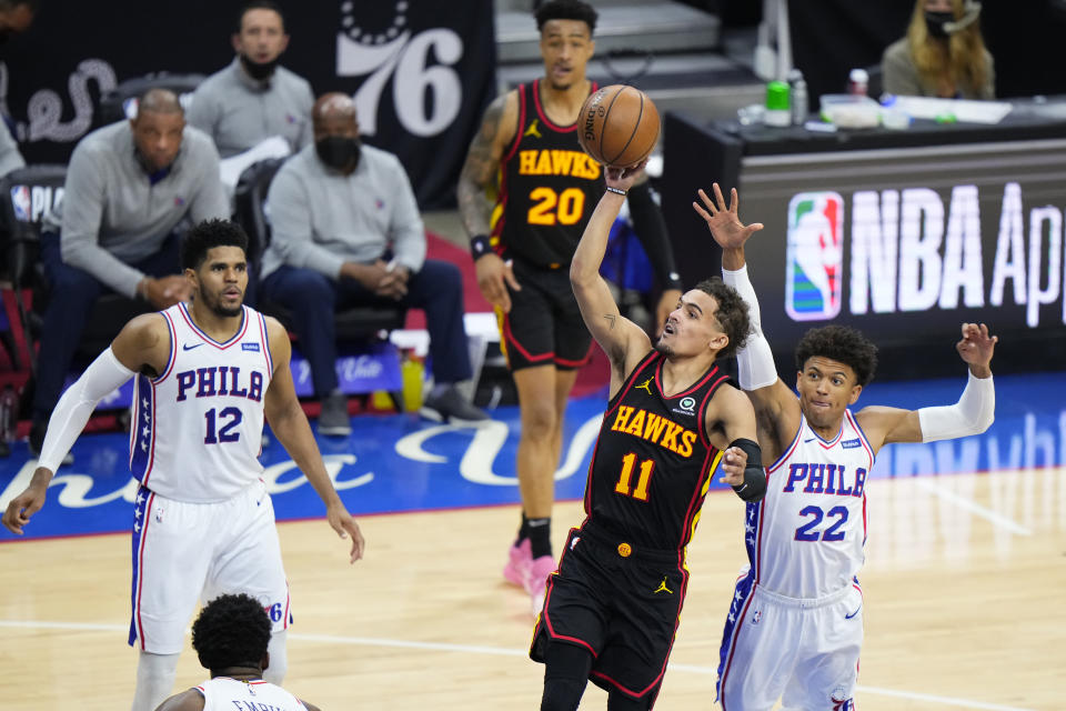 Atlanta Hawks' Trae Young (11) goes up for a shot against Philadelphia 76ers' Matisse Thybulle (22) during the second half of Game 7 in a second-round NBA basketball playoff series, Sunday, June 20, 2021, in Philadelphia. (AP Photo/Matt Slocum)