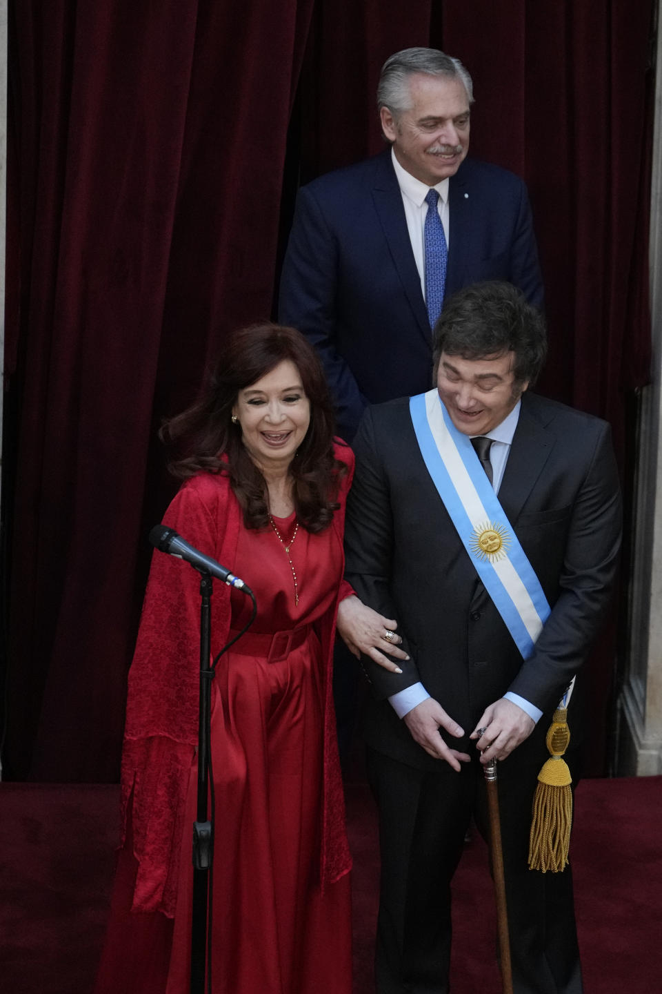 Outgoing Vice-president Cristina Fernandez, left, and Argentina's incoming President Javier Milei laugh during his swearing-in ceremony at Congress in Buenos Aires, Argentina, Sunday, Dec. 10, 2023. At the back outgoing President Alberto Fernandez. (AP Photo/Natacha Pisarenko)