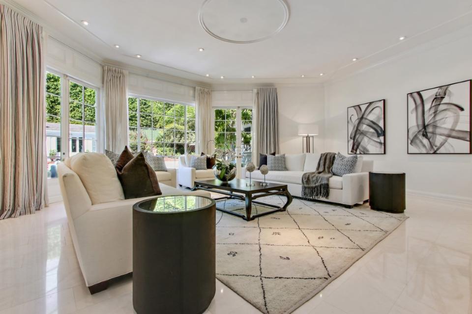 <p>The elegant living room features high ceilings and French doors. (Sotheby’s International Realty) </p>