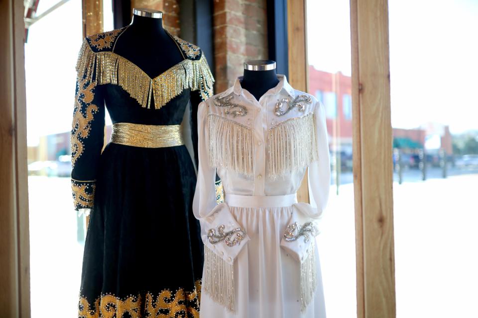 Iconic outfits from Reba McEntire's career are on display at her new restaurant in Atoka, Reba's Place.